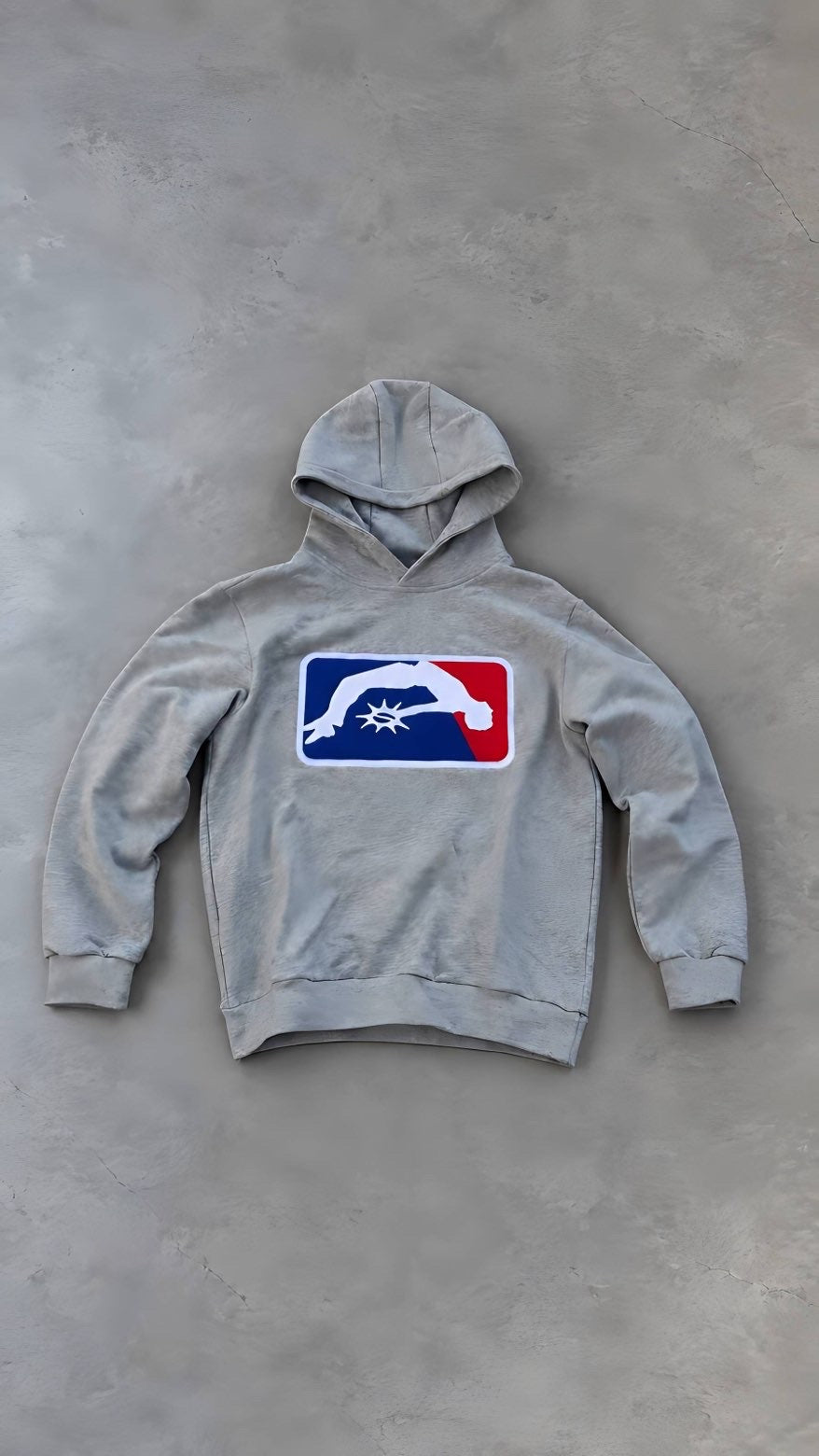 Solaire Hoodie in grey laid flat on grey concrete