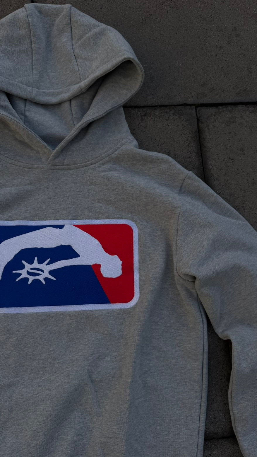 Close-up of the red, white and blue chest badge on the Solaire Hoodie