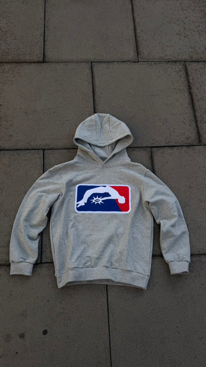 Solaire Hoodie in grey laid flat on paving, front view